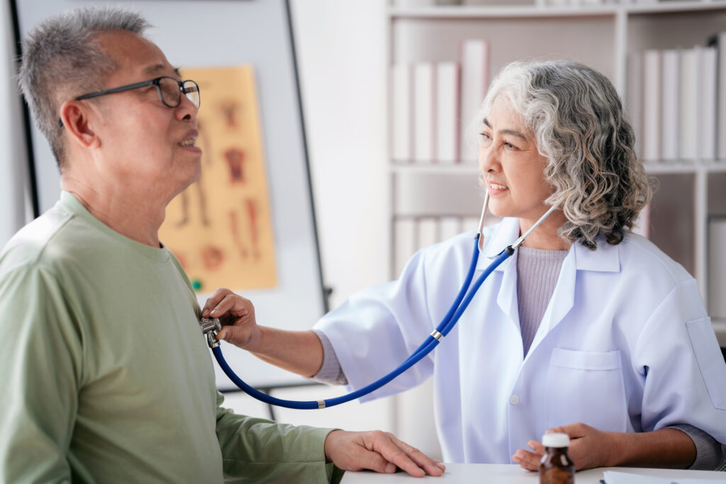 doctor using stethoscope to listening heart rate of senior patient and explaining healthcare for