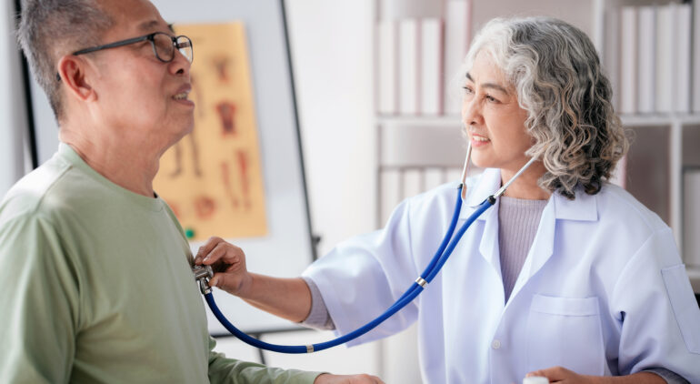 doctor using stethoscope to listening heart rate of senior patient and explaining healthcare for